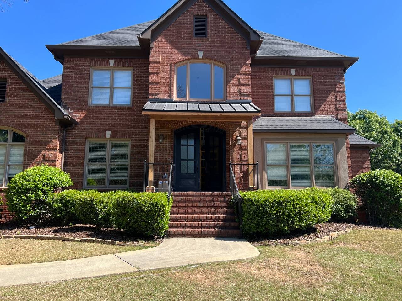Two-story brick home after a window replacement