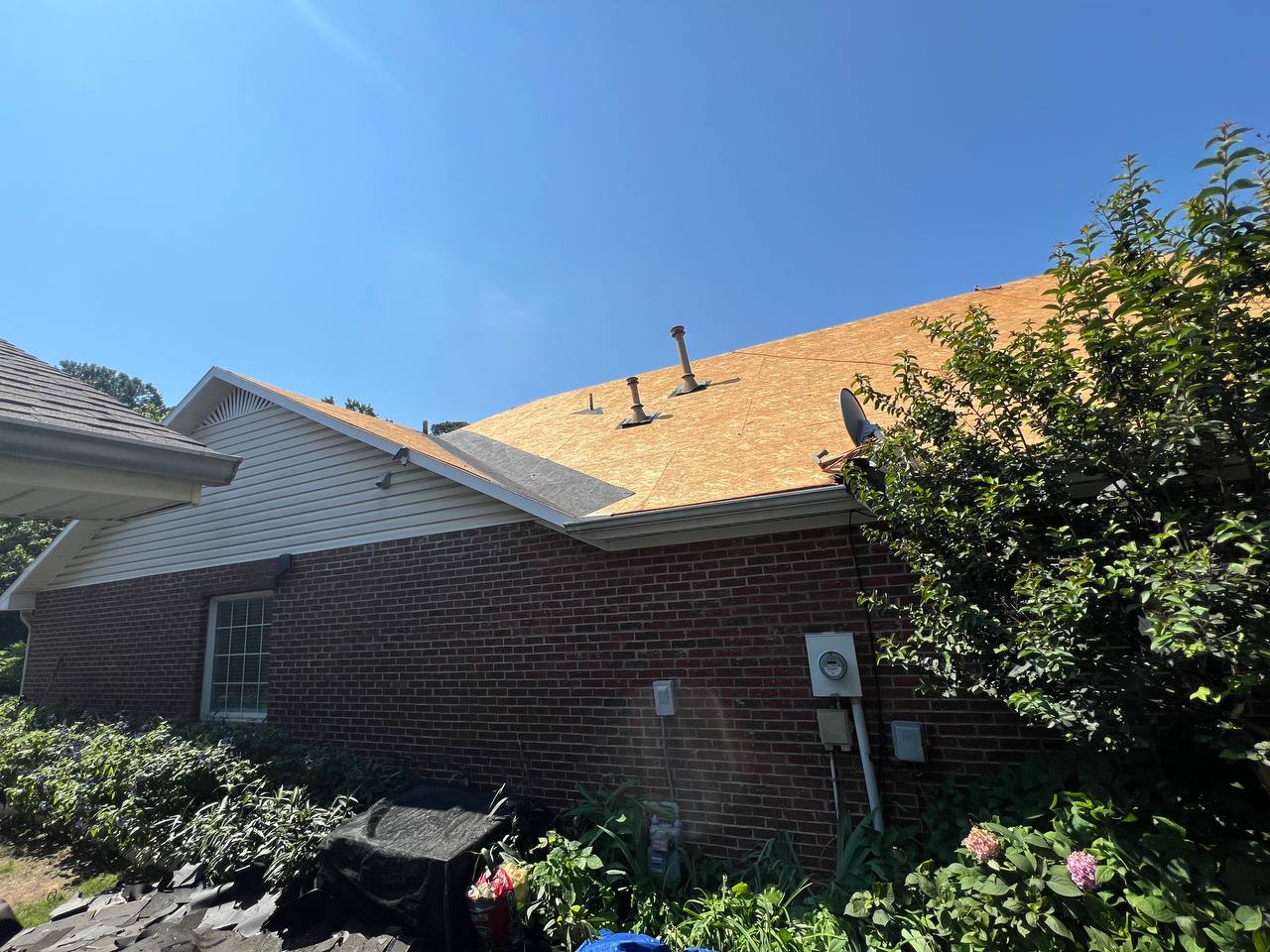 Tyler Roofing crew standing on fresh roof decking during a residential replacement